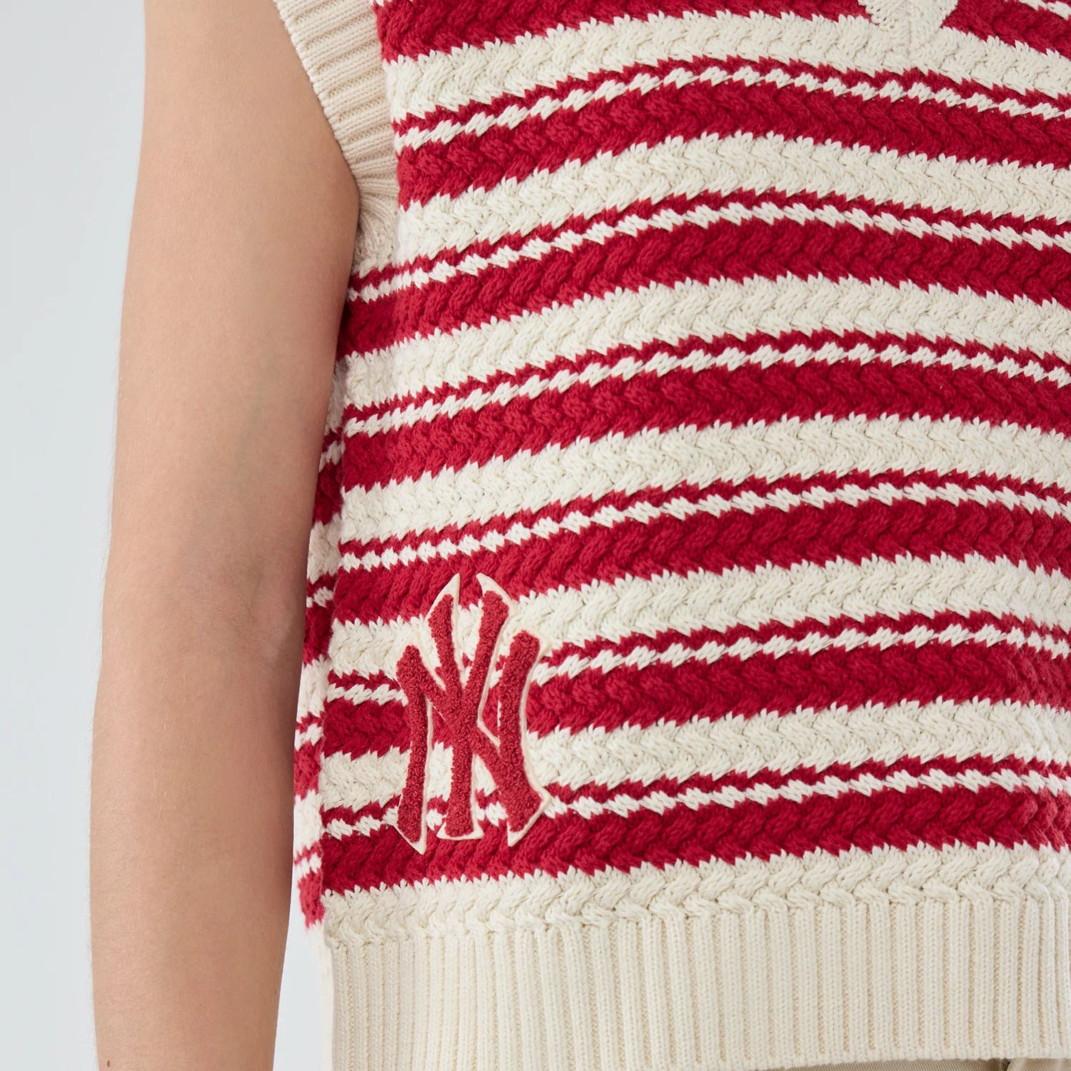 The model is wearing this Womens MLB Knit Stripe New York Yankees Sleeveless V-neck Sweater in dark red. 3