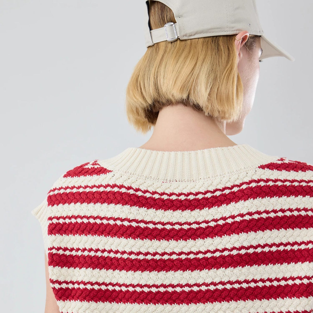 The model is wearing this Womens MLB Knit Stripe New York Yankees Sleeveless V-neck Sweater in dark red. 7
