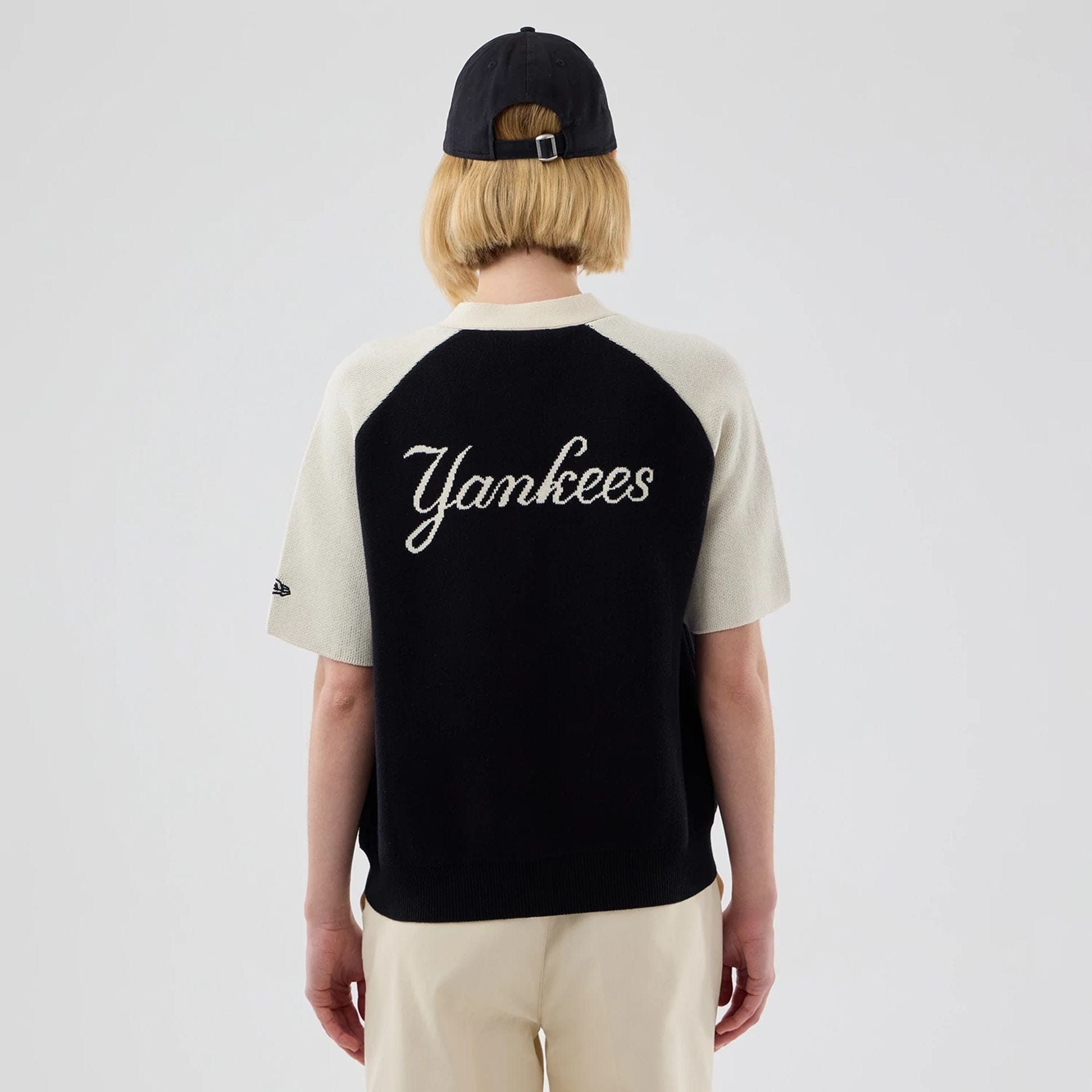 The model is wearing this Womens MLB Knit Stripe New York Yankees Short Sleeve Cardigan in black. 2