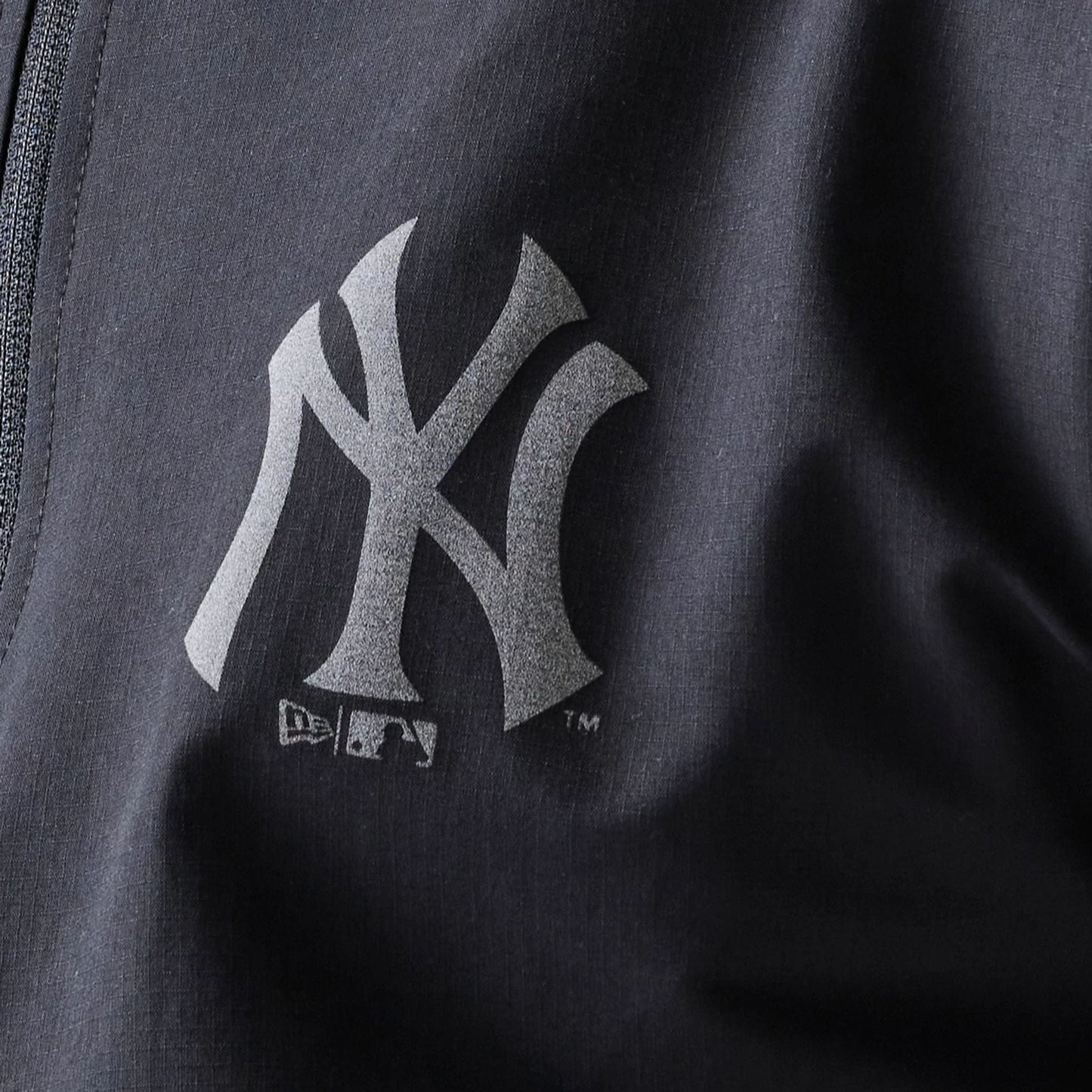 The model is wearing this MLB New York Yankees Track Jacket in black. 8