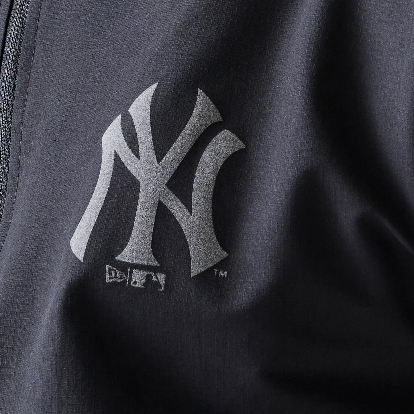 The model is wearing this MLB New York Yankees Track Jacket in black. 8