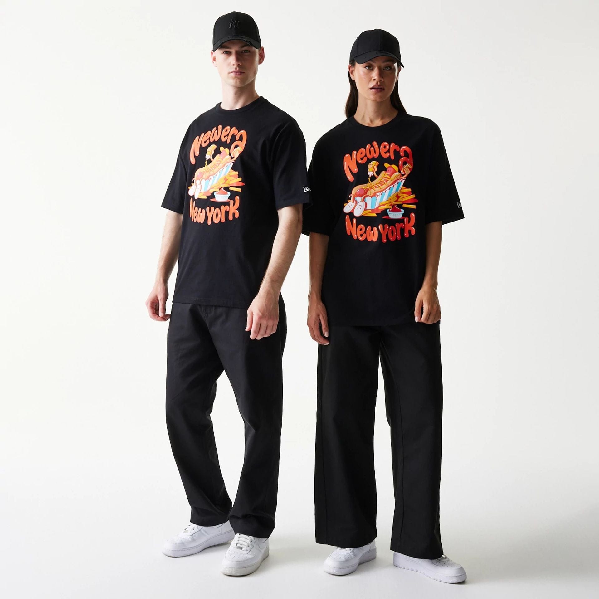 The model is wearing this New Era Hotdog Food Graphic Oversized T-Shirt in black. 1