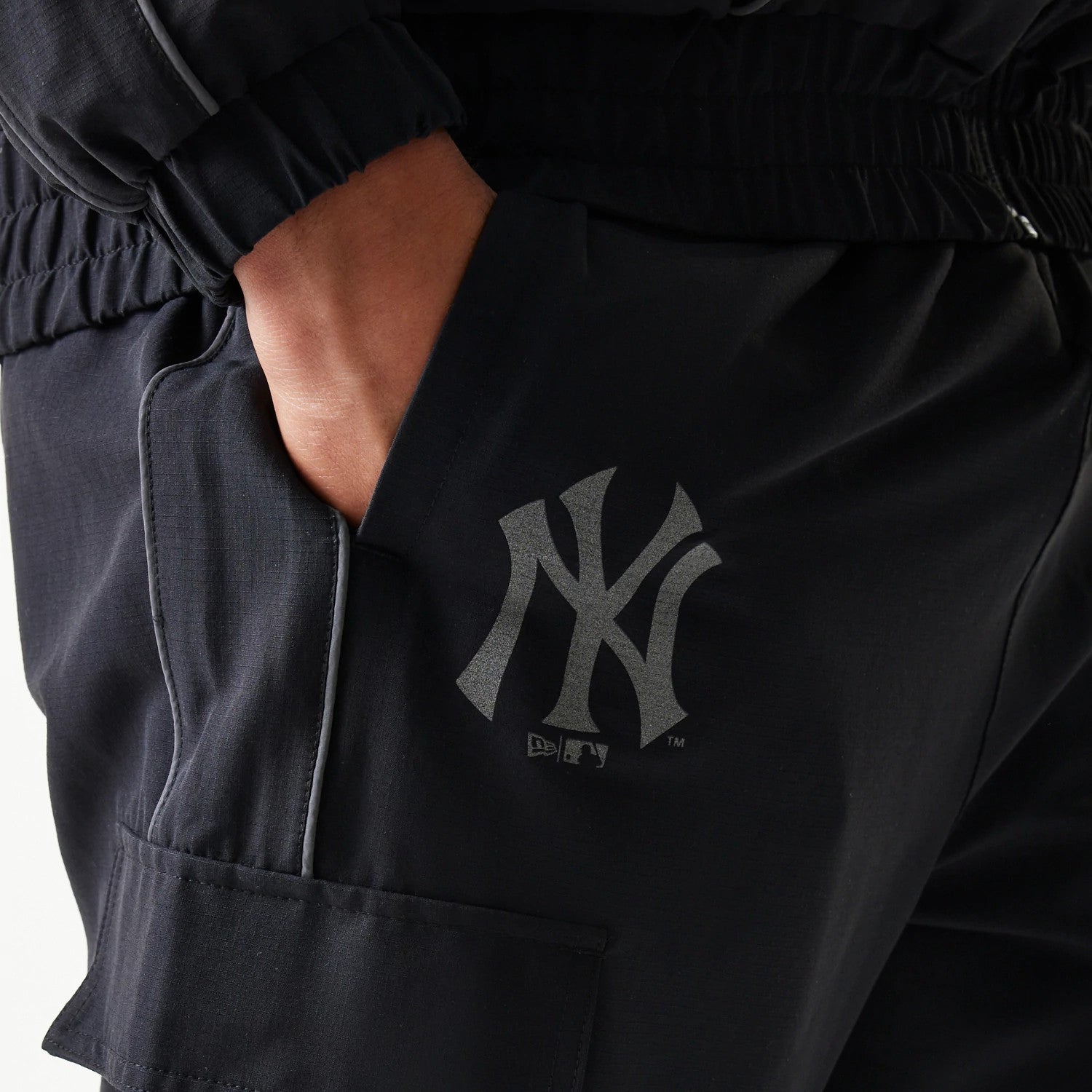 The model is wearing this MLB Utility New York Yankees Straight Leg Cargo Joggers in black. 4