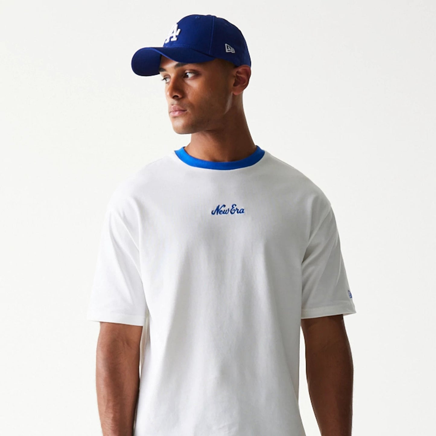 The model is wearing this New Era Script Oversized T-Shirt in white. 8