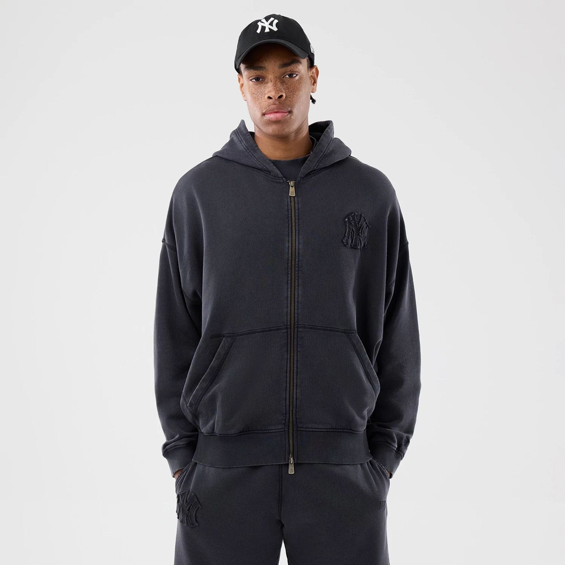 The model is wearing this MLB Washed New York Yankees Full Zip Hoodie in black. 1