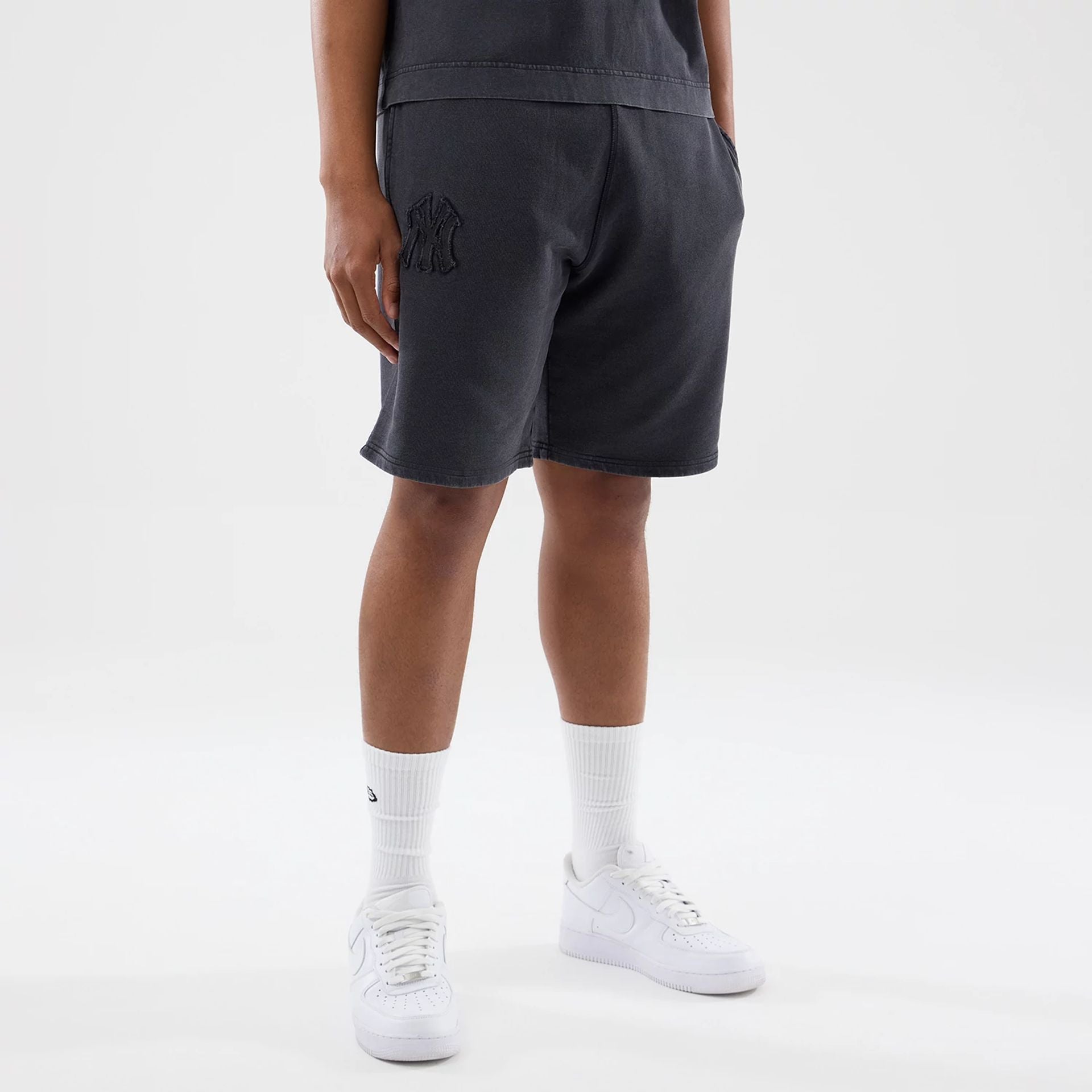 The model is wearing this MLB Washed New York Yankees Shorts in black. 1