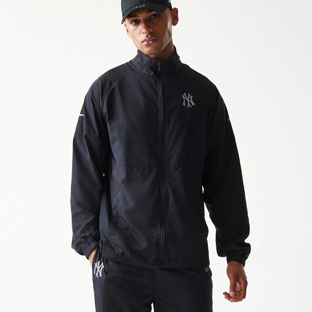 The model is wearing this MLB Reflective Strip New York Yankees Jacket in black. 4