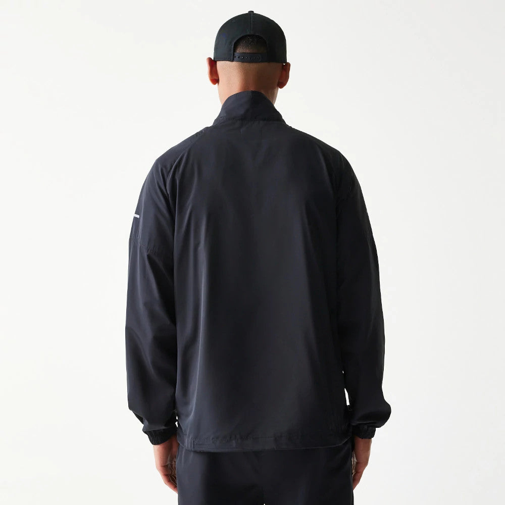 New Era New York Yankees MLB Reflective Strip Black Jacket, back view on a model showing a solid black design with long sleeves, reflective strip detail on the left arm, and a high collar for added style.