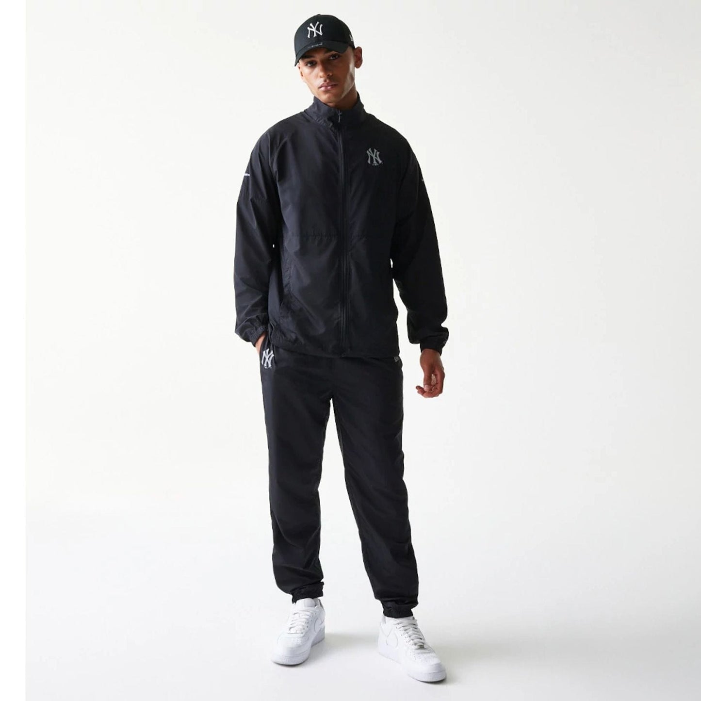 The model is wearing this MLB Reflective Strip New York Yankees Jacket in black. 8
