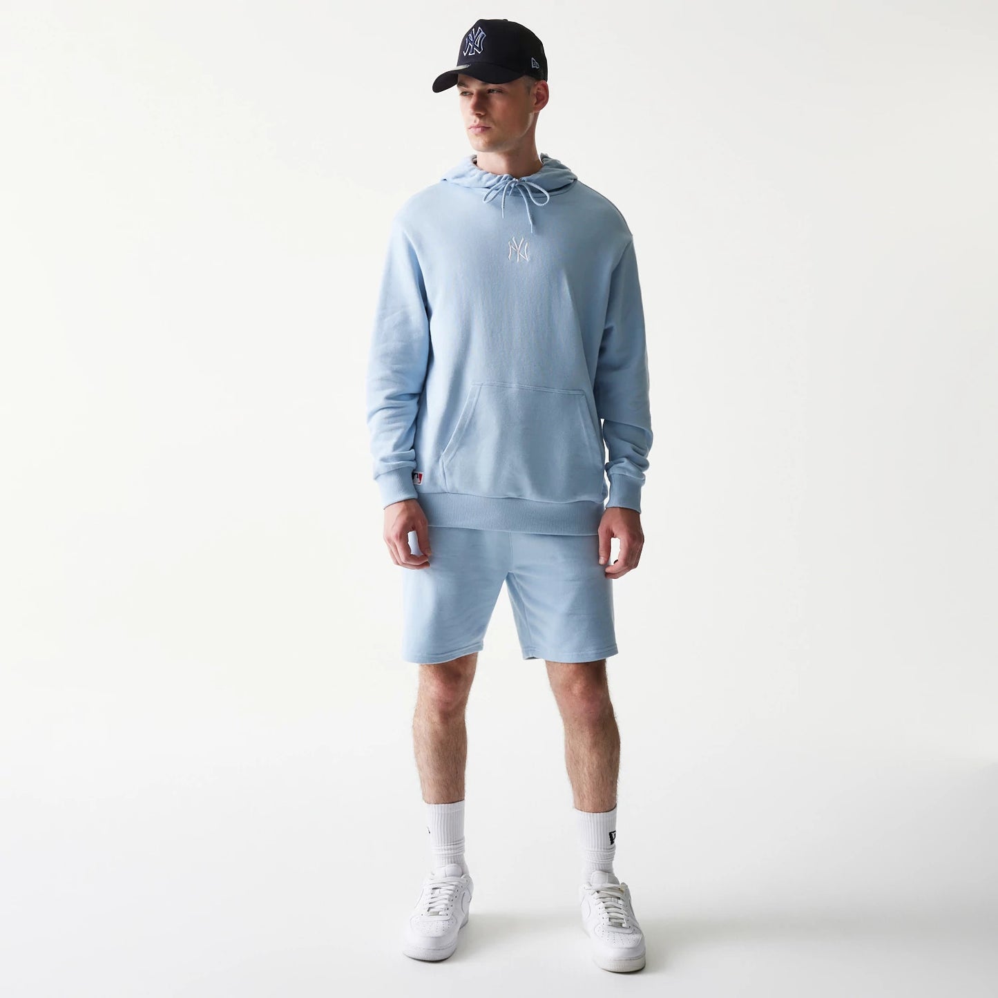 The model is wearing this MLB League Essential Midi New York Yankees Oversized Pullover Hoodie in pastel blue. 8