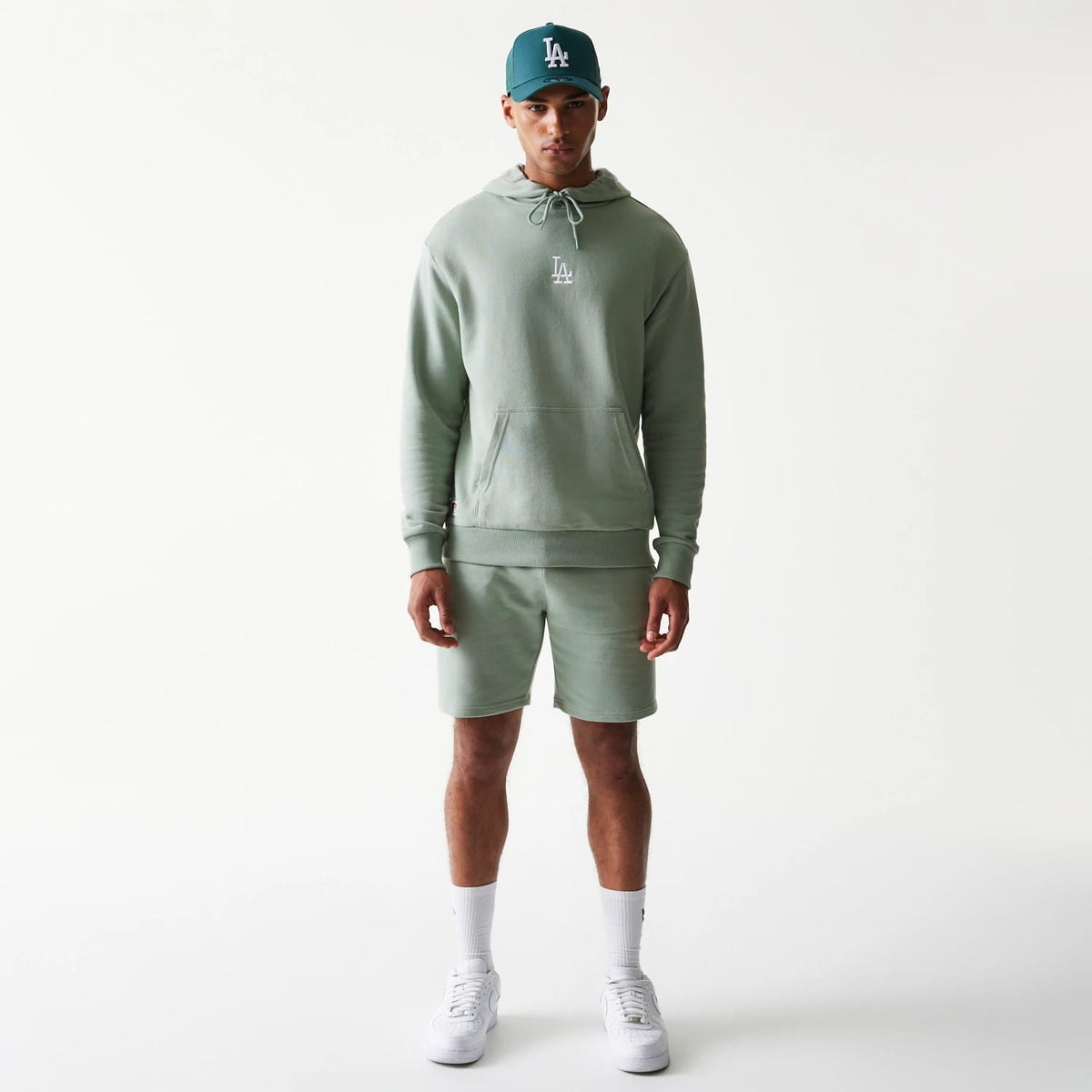 The model is wearing this MLB League Essential Midi LA Dodgers Oversized Pullover Hoodie in green. 8