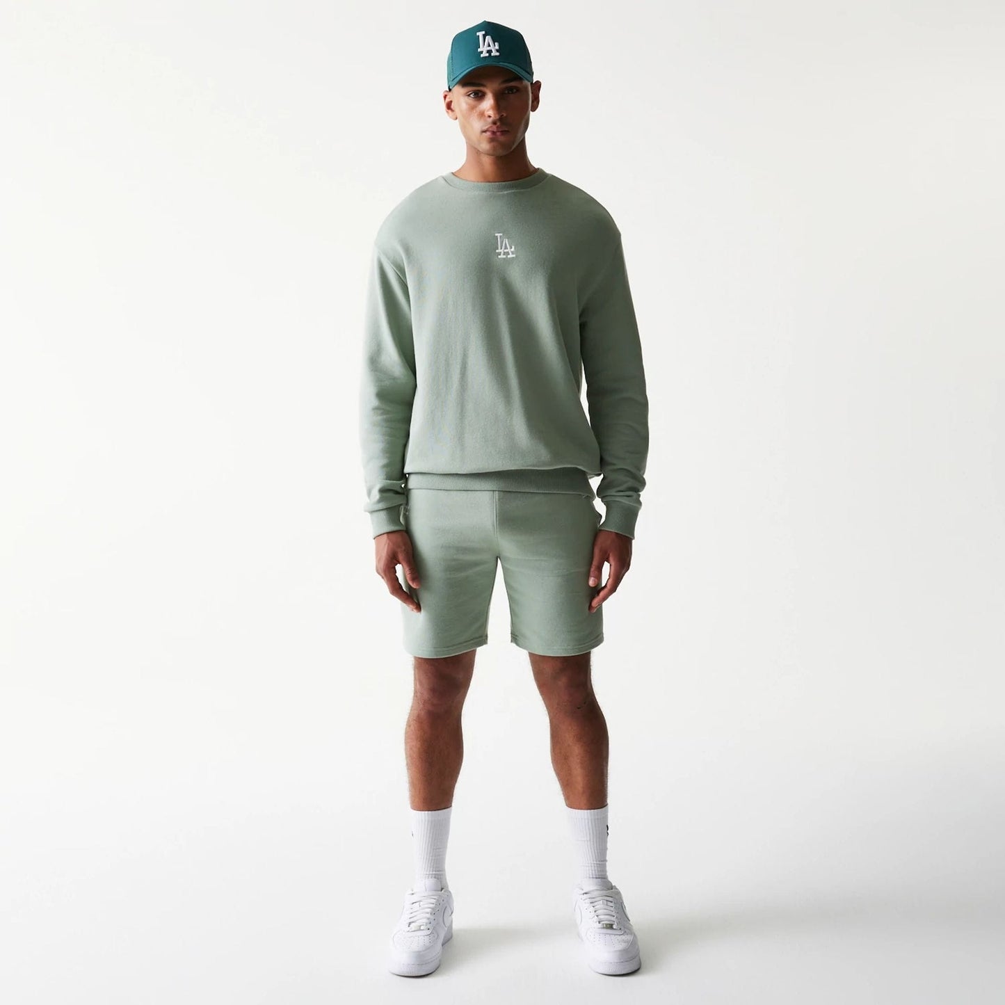 The model is wearing this MLB League Essential Midi LA Dodgers Shorts in pastel green. 8