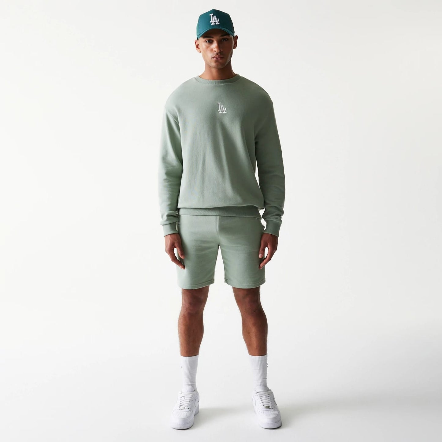 The model is wearing this MLB League Essential Midi LA Dodgers Shorts in green. 8