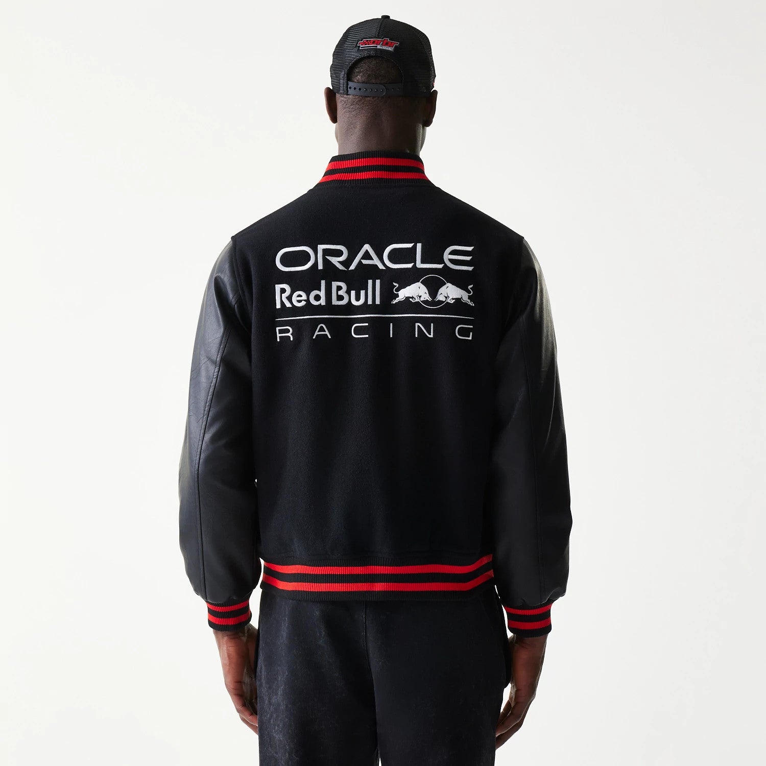 The model is wearing this Red Bull Racing Varsity Jacket in black. 2