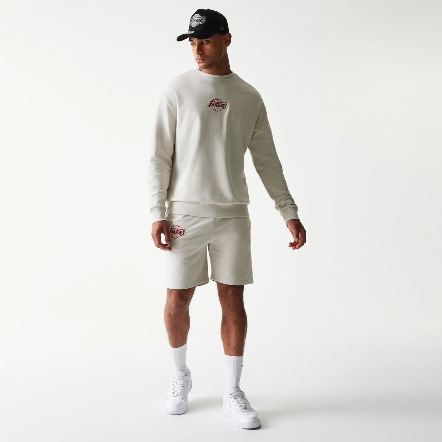 The model is wearing this NBA League Essential LA Lakers Shorts in light beige. 8