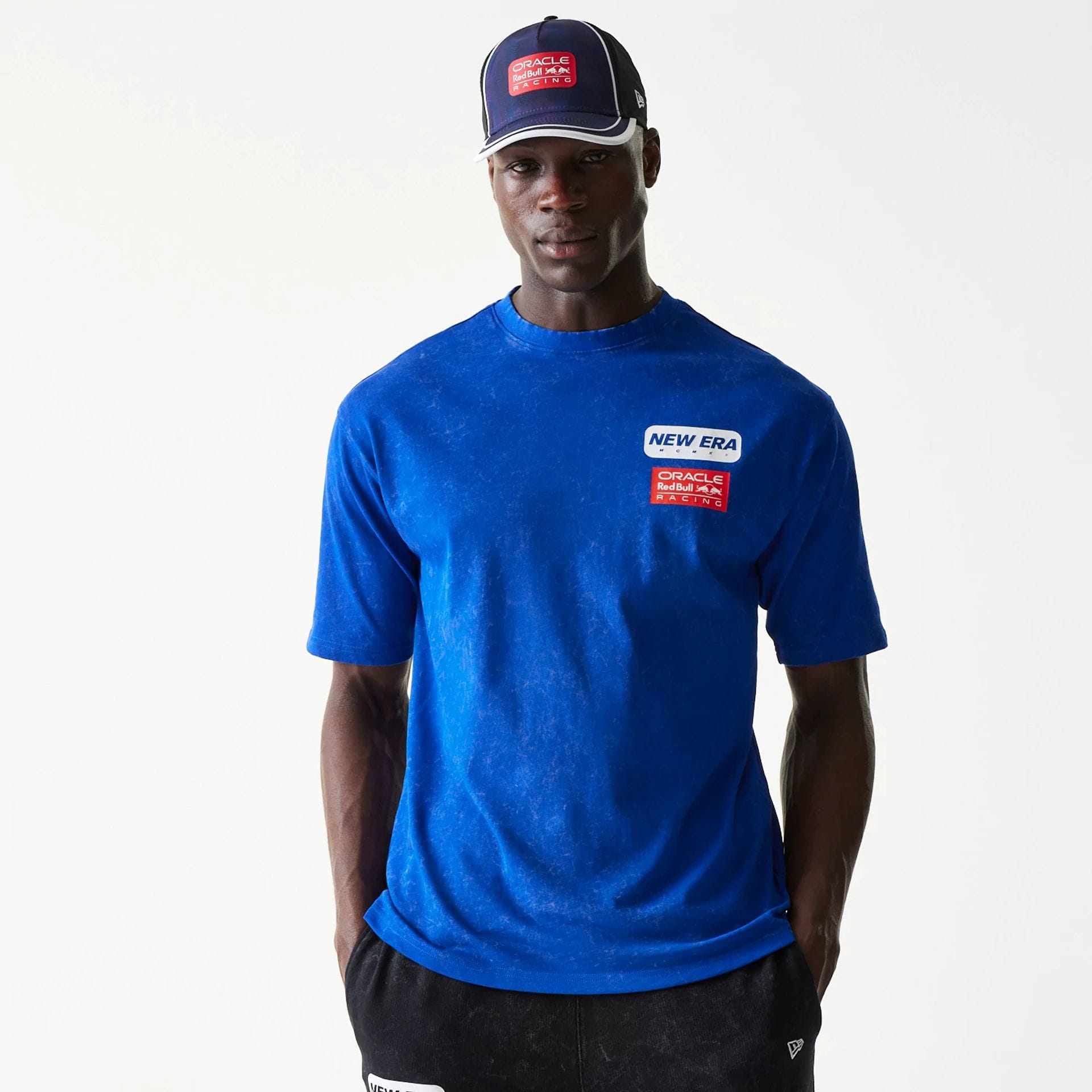 The model is wearing this Red Bull Racing Linear Graphic Oversized T-Shirt in blue. 1
