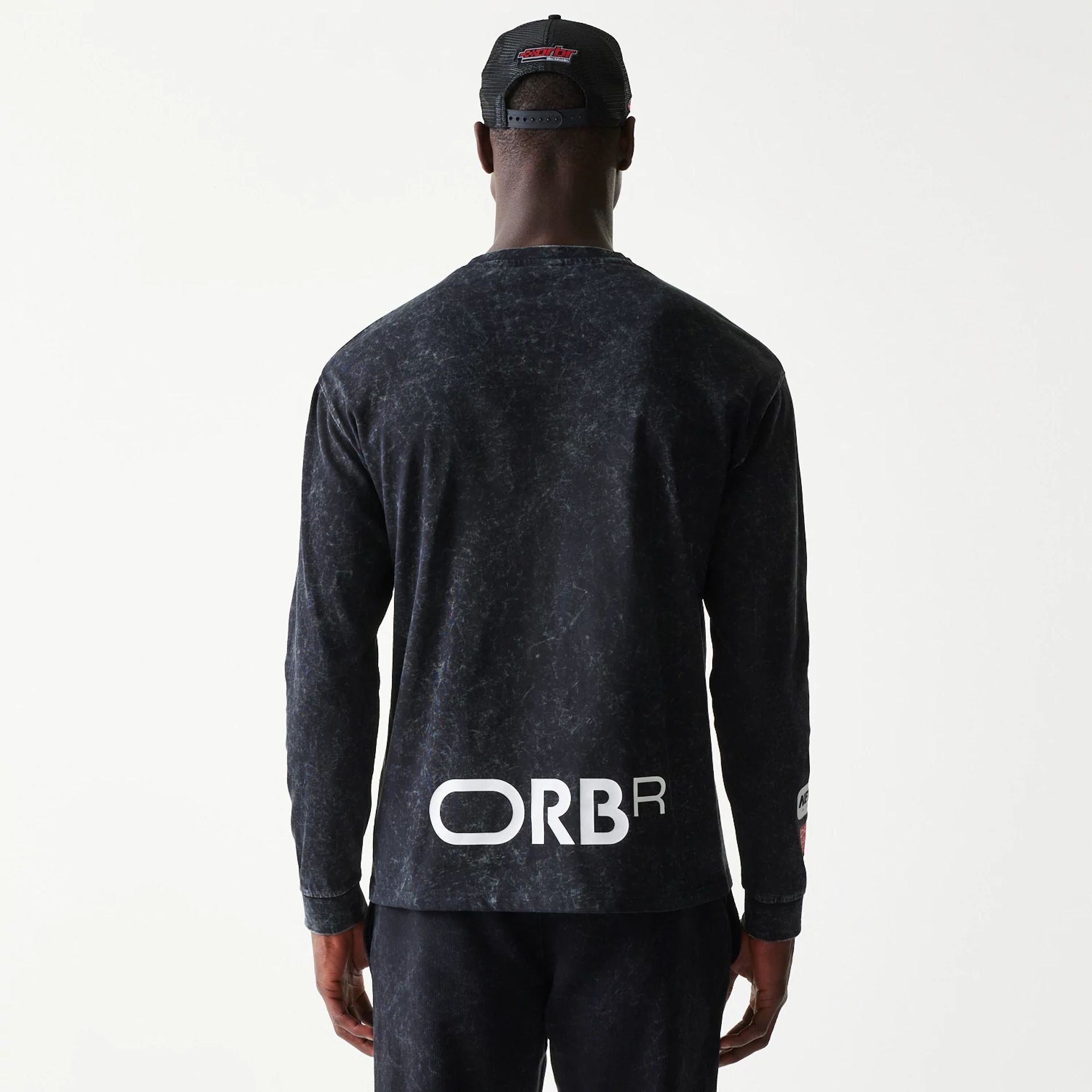 The model is wearing this Red Bull Racing Linear Graphic Long Sleeve T-Shirt in black. 2