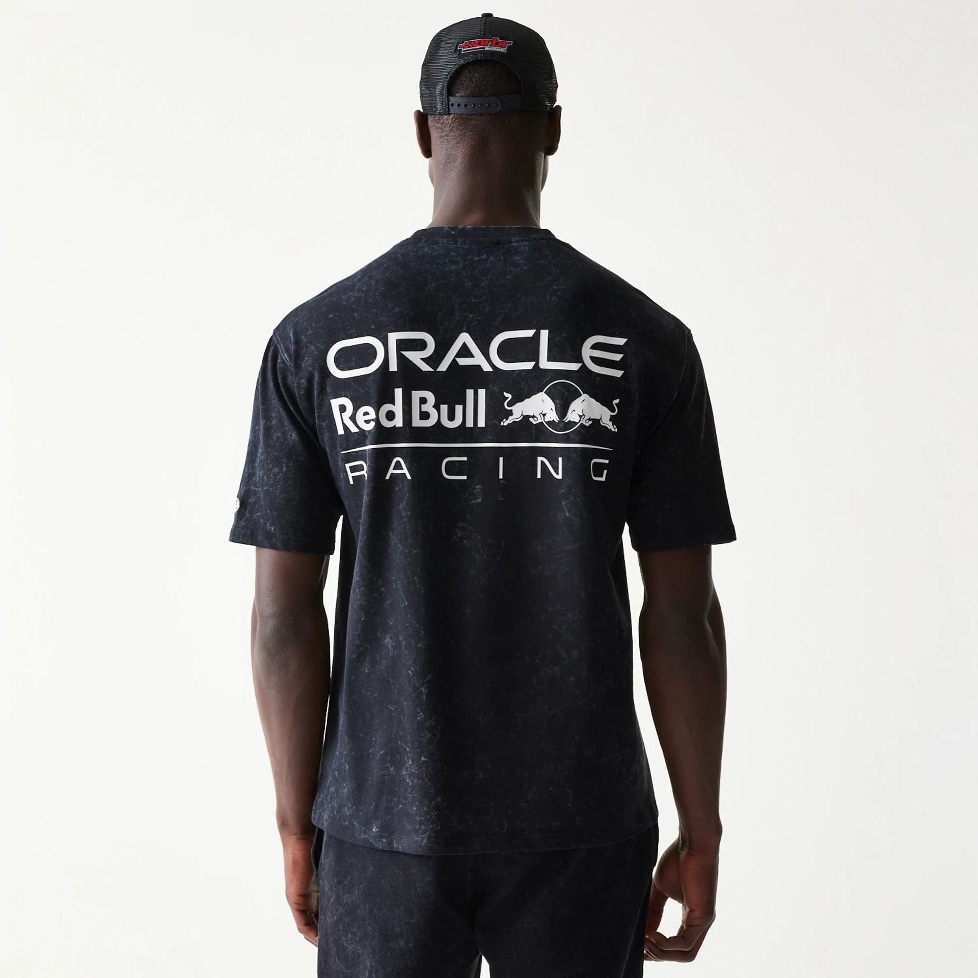 The model is wearing this Red Bull Racing Linear Graphic Oversized T-Shirt in black. 2