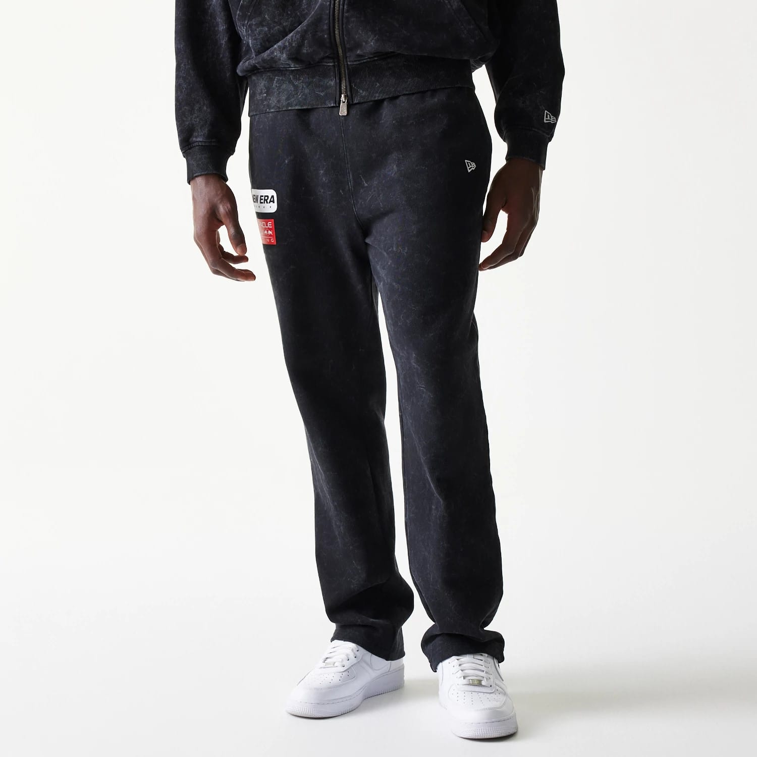 New Era Red Bull Racing Straight Leg Black Straight Leg Joggers, front view on a model showing the New Era patch on the left thigh, a washed effect, and a small embroidered New Era flag logo on the right pocket.