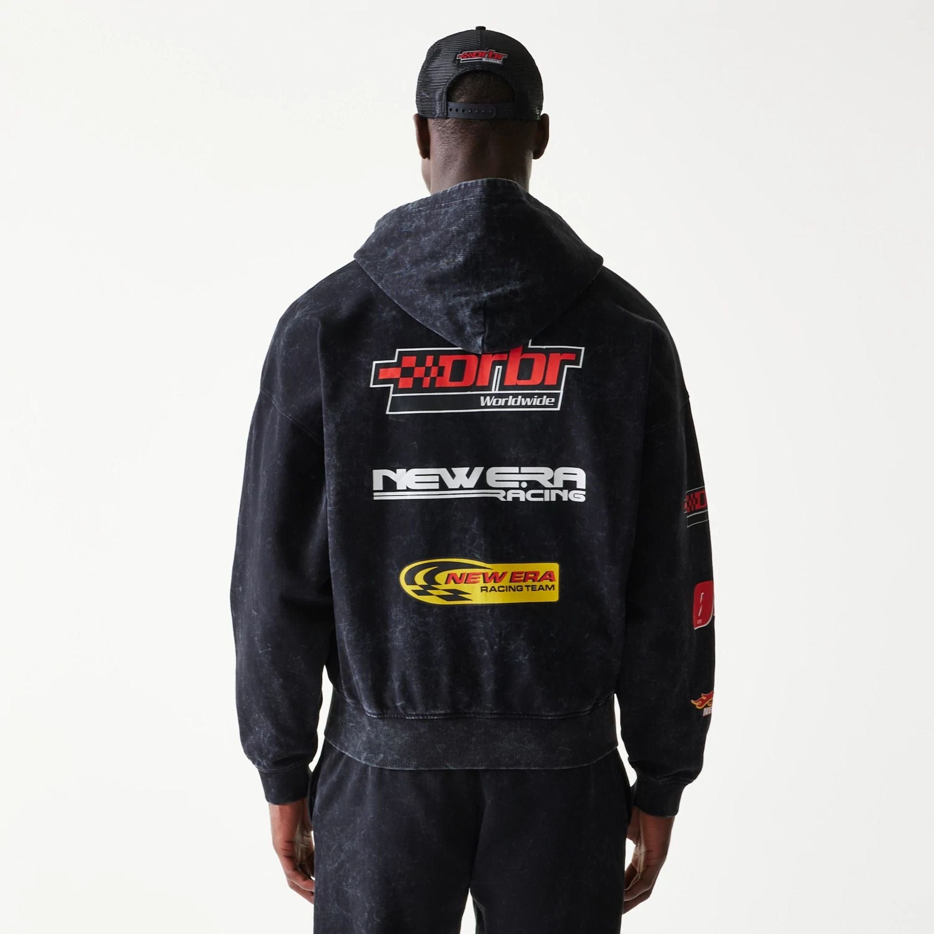 The model is wearing this Red Bull Racing Graphic Dropped Shoulder Full Zip Hoodie in black. 2