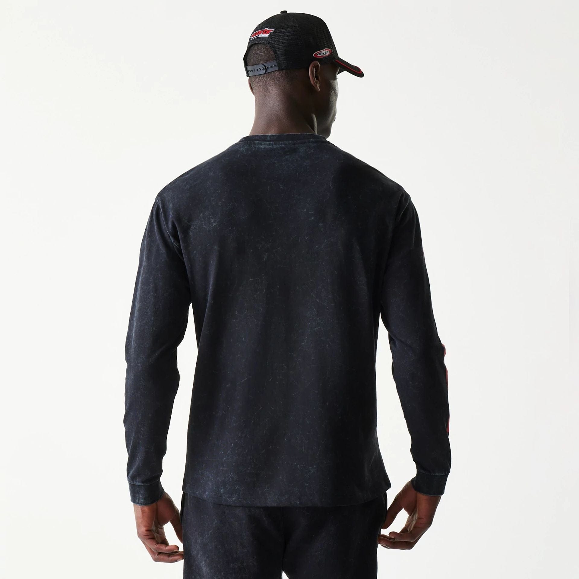 The model is wearing this Red Bull Racing Graphic Long Sleeve T-Shirt in black. 2