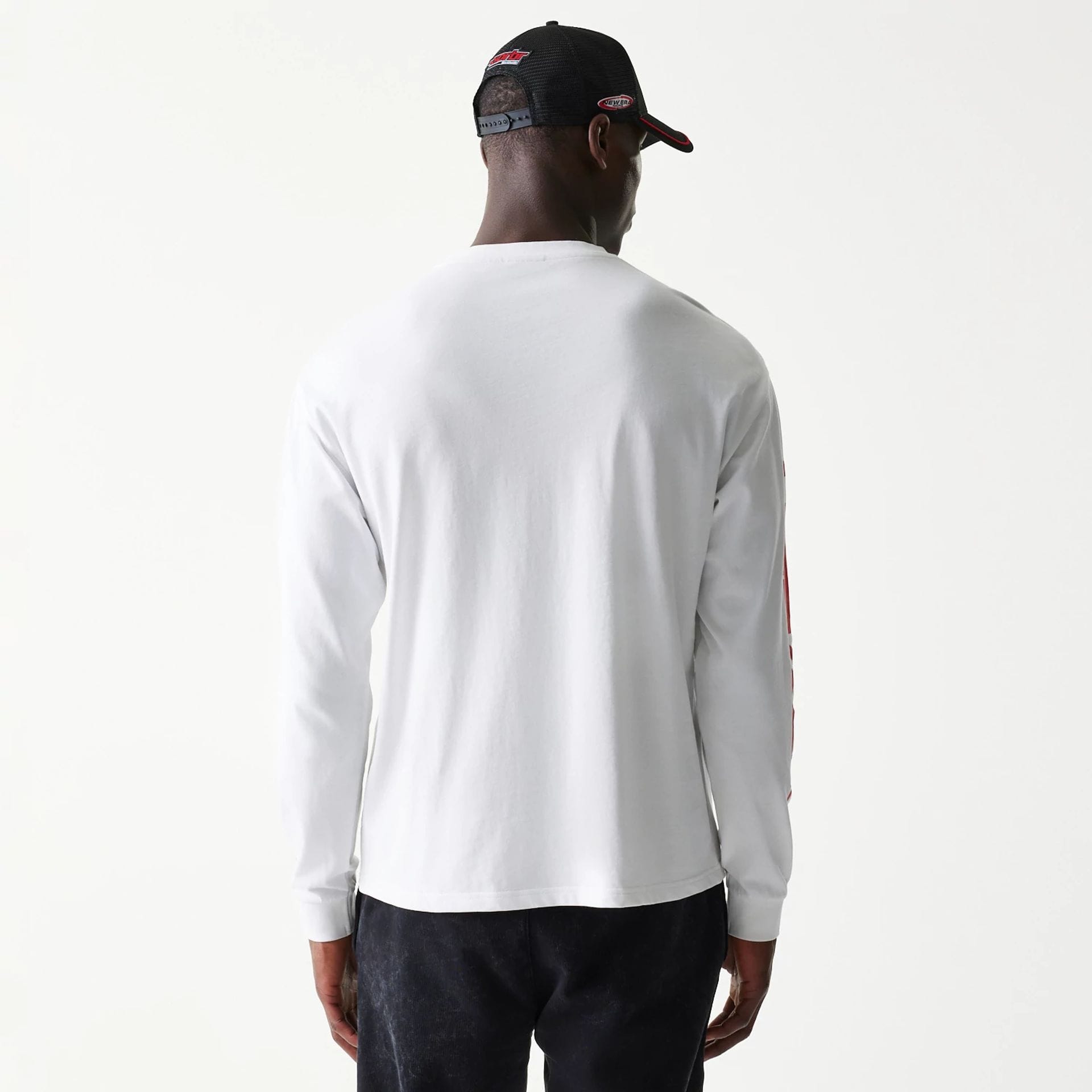 The model is wearing this Red Bull Racing Graphic Long Sleeve T-Shirt in white. 2