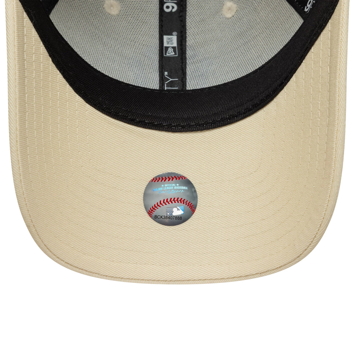 New York Yankees Womens MLB Metallic Logo Light Beige New Era 9FORTY Cap, inside view showing black sweatband, contrasting dark taping with New Era branding, light beige undervisor, and a grey MLB authenticity sticker.