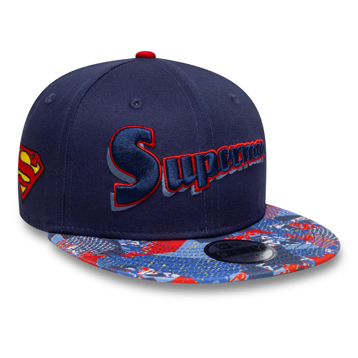 Youth DC Superman Navy New Era 9FIFTY Snapback Cap, three-quarter view showing the dark blue and red embroidered Superman logo on the front panel, a side Superman shield logo, and a colourful patterned flat visor with a 9FIFTY size sticker.