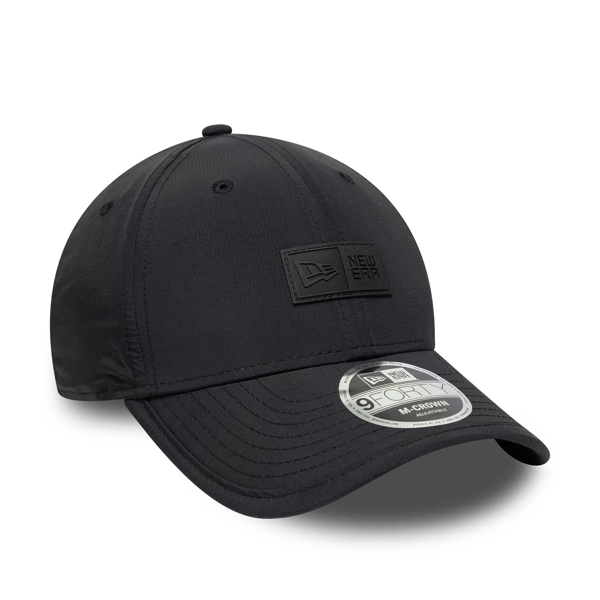 New Era Sport Black 9FORTY M-Crown Cap, three-quarter view showing the black raised logo patch on the front panel and curved visor with a 9FORTY size sticker, featuring stitched eyelets and a top button.