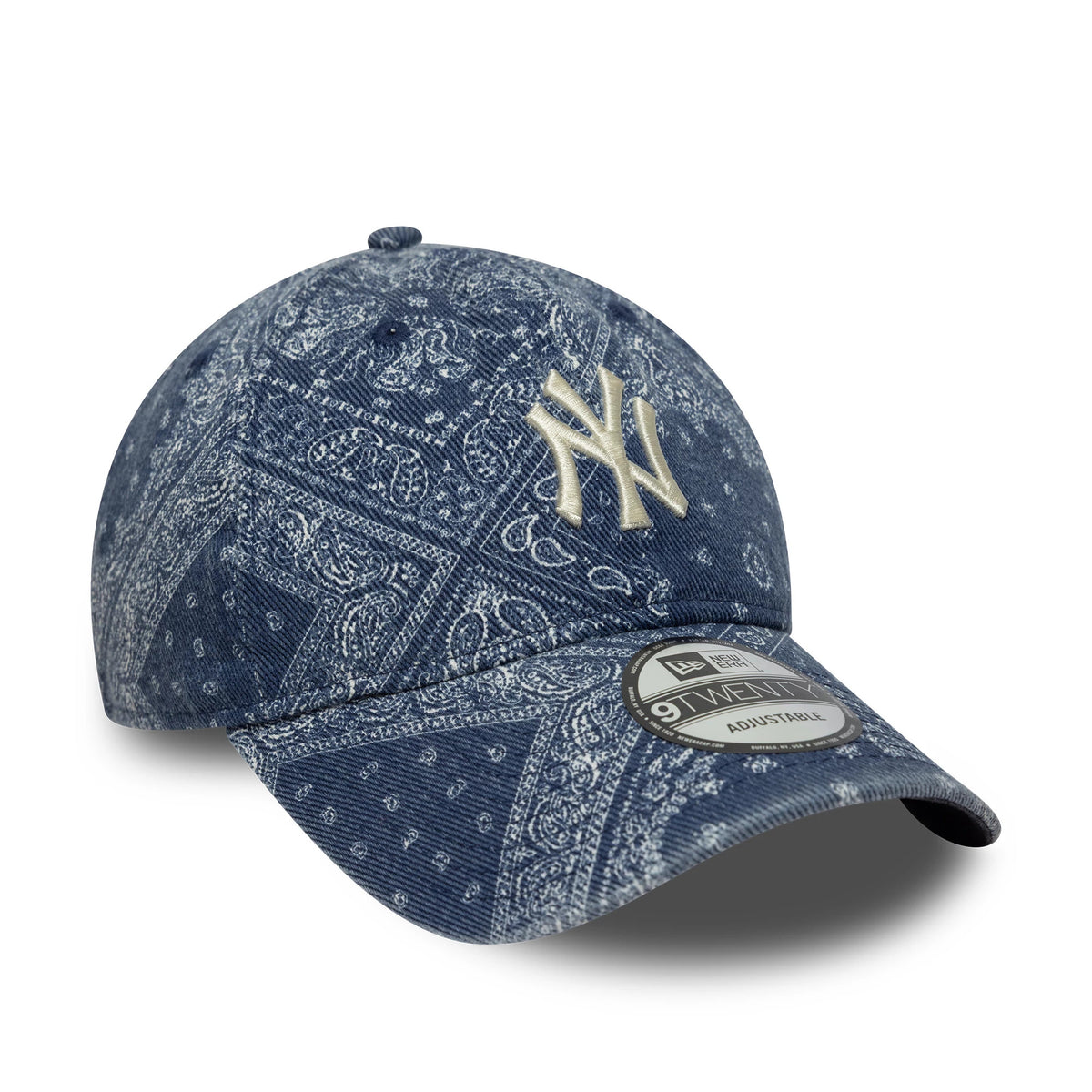 New York Yankees MLB Washed Paisley Navy New Era 9TWENTY Cap, three-quarter view showing a raised beige NY logo embroidered on the front panel, detailed paisley design across the navy fabric, and a 9TWENTY size sticker on the curved visor.