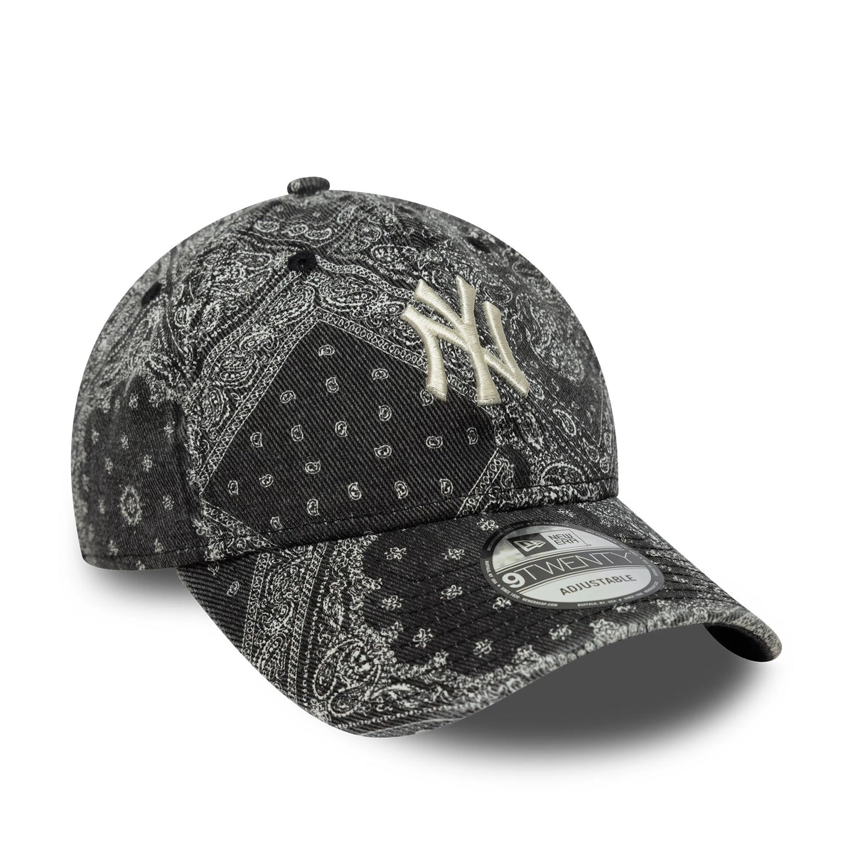 New York Yankees MLB Washed Paisley Black New Era 9TWENTY Cap, three-quarter view showing the beige embroidered NY logo on the front panel, a black curved visor with a 9TWENTY size sticker, and an intricate paisley pattern covering the entire cap.