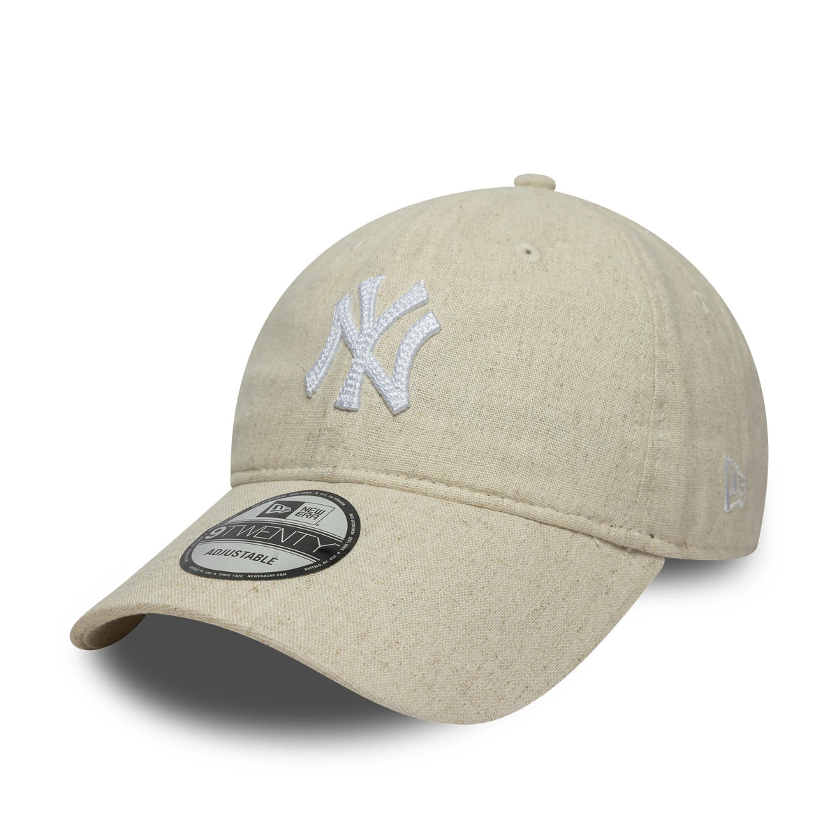 New York Yankees MLB Linen Light Beige New Era 9TWENTY Adjustable Cap, three-quarter view showing the white raised embroidered NY logo on the front panel, a curved visor with a 9TWENTY size sticker, and the New Era flag logo on the left side.