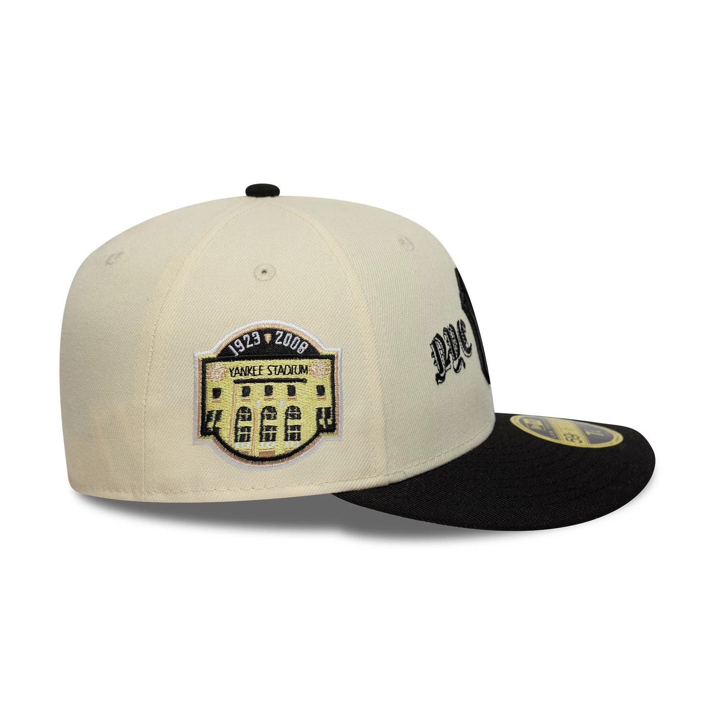 New York Yankees MLB Cooperstown Cream Low Profile New Era 59FIFTY Fitted Cap, side view showing a detailed Yankee Stadium patch on the mid panel with a black embroidered NYC script on the front panel.