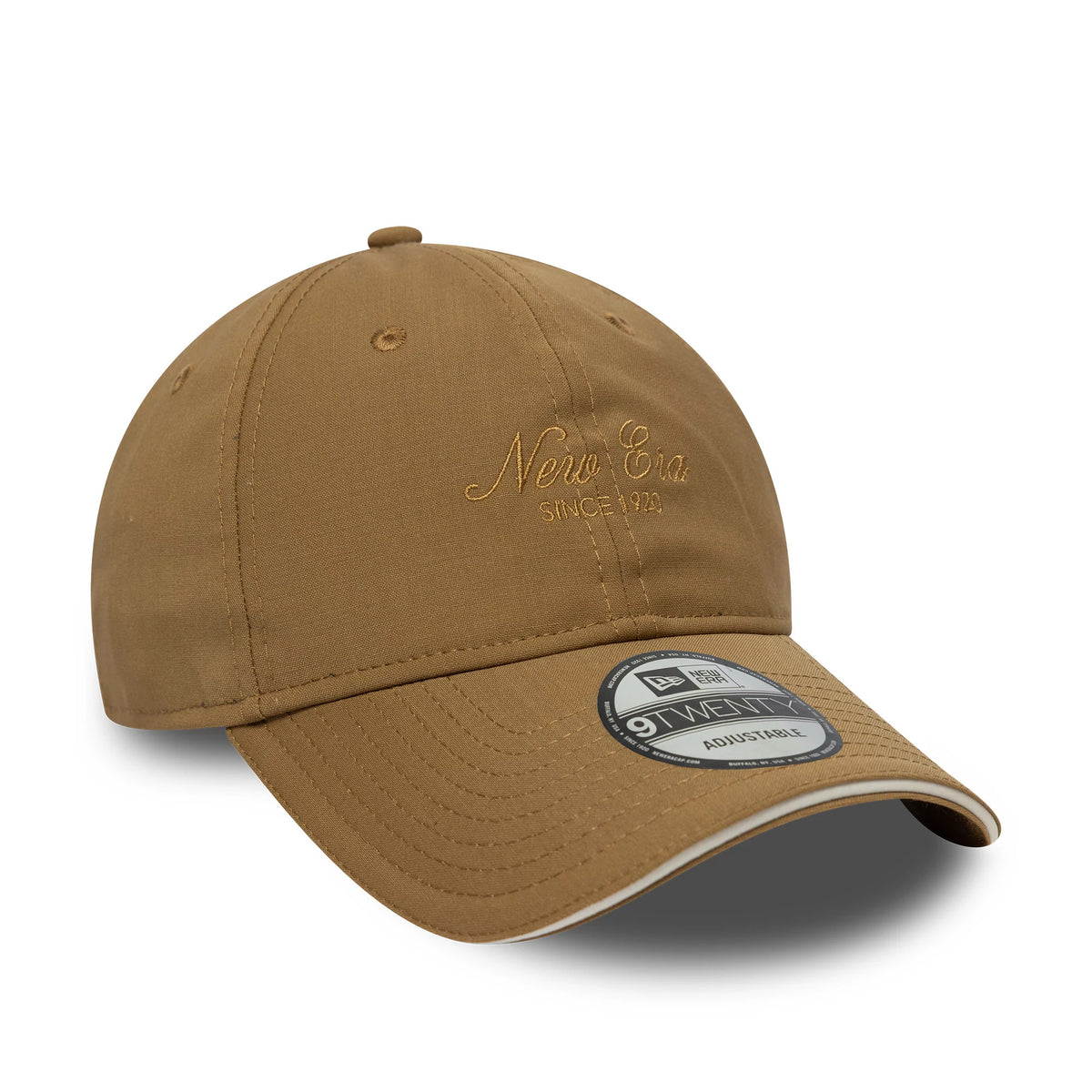 New Era Heritage Light Beige 9TWENTY Cap, three-quarter view showing the matching beige embroidered New Era logo on the front panel, curved visor with a 9TWENTY size sticker, and beige eyelets and top button.