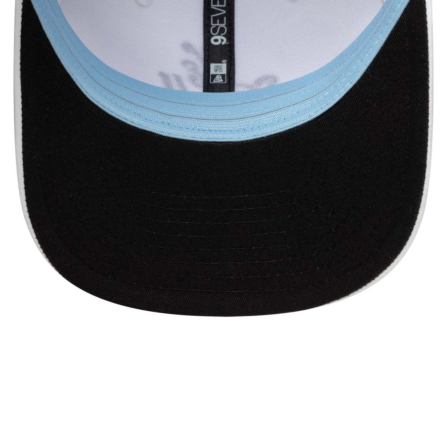 New Era Technical White 9SEVENTY Stretch Snap Adjustable Cap, inside view showing the light blue undervisor, black curved visor, and black sweatband with the 9SEVENTY branding on the taping.