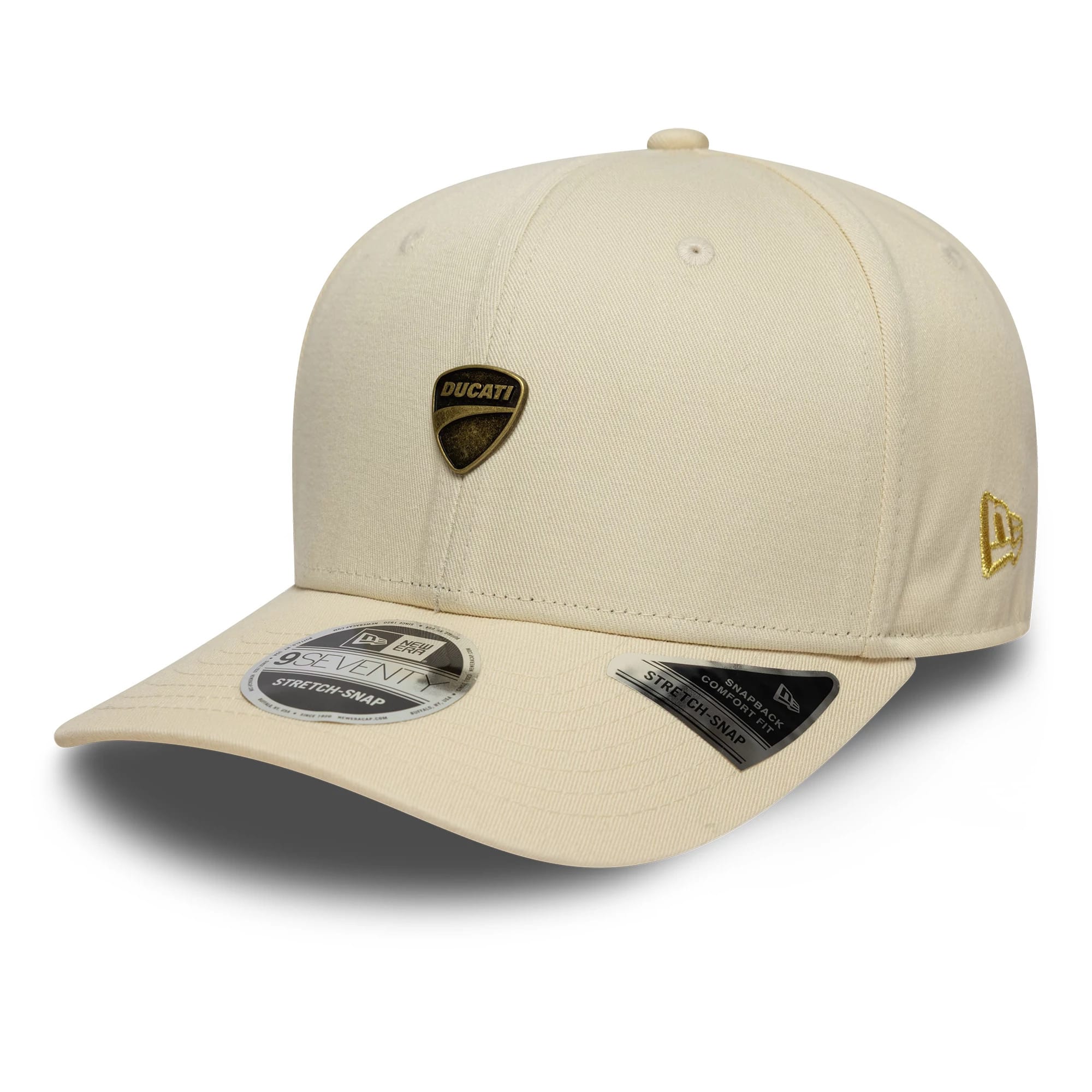Ducati Motor Logo Light Beige New Era 9SEVENTY Stretch Snap Cap, three-quarter view showing the gold Ducati shield logo on the front panel, a curved visor with a 9SEVENTY size sticker, and the New Era flag logo on the left side.