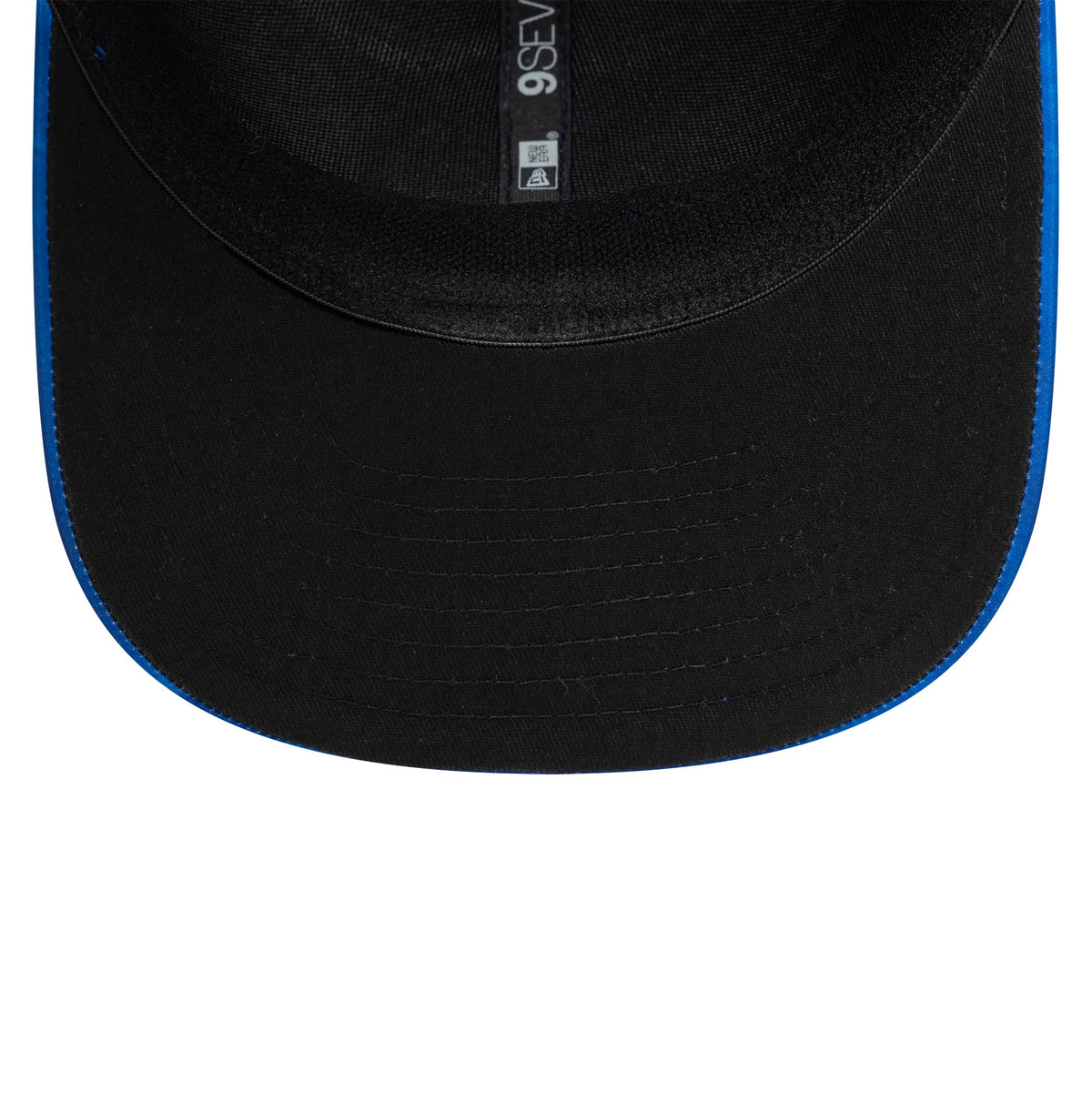 Newcastle United FC 1993 Open Blue New Era 9SEVENTY Stretch Snap Cap, inside view showing the black sweatband, black undervisor with stitching, and internal taping with the 9SEVENTY logo in white text.