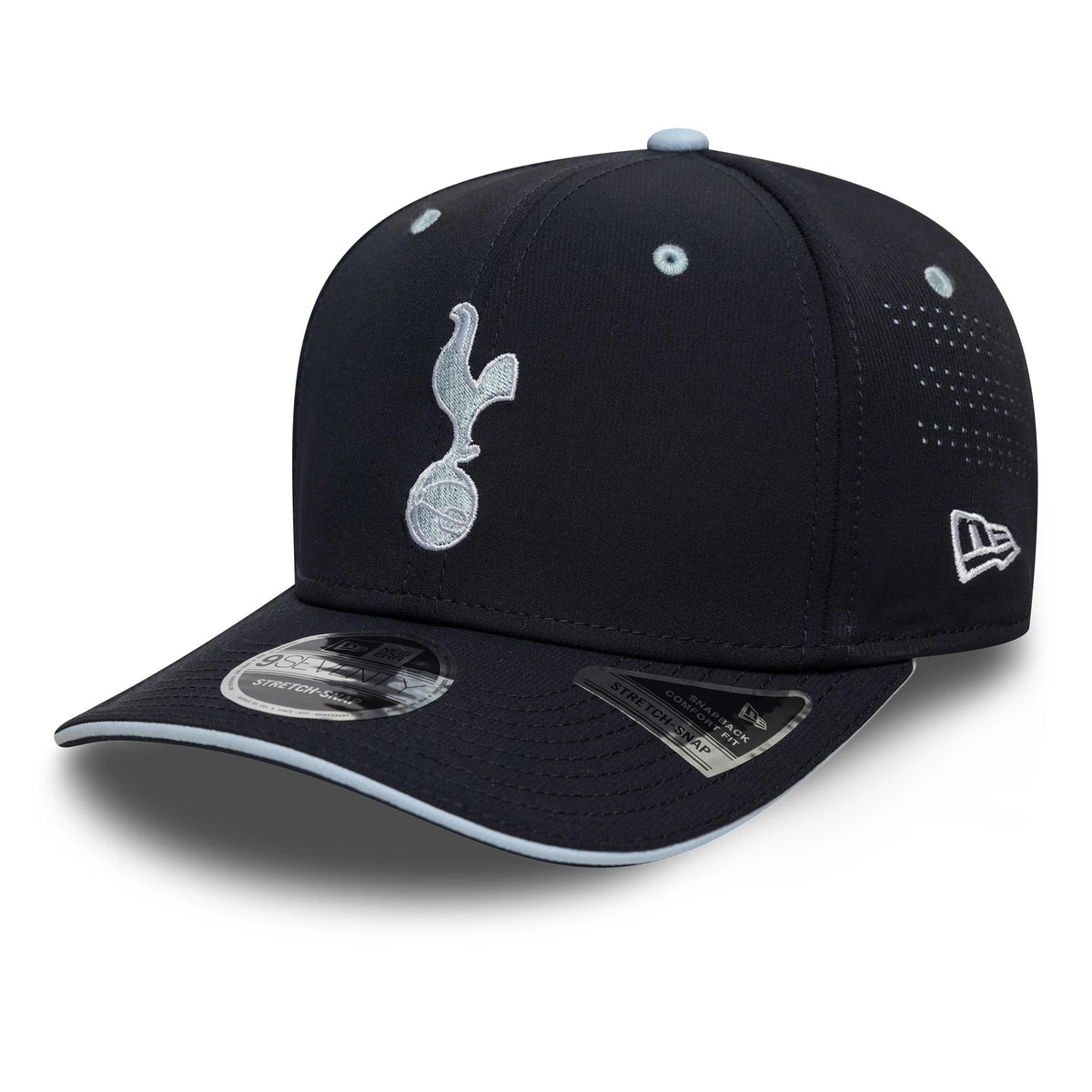 Tottenham Hotspur FC Cockerel Navy New Era 9SEVENTY Stretch Snap Cap, front view showing a light blue embroidered cockerel emblem on the front panel, navy curved visor with size sticker, and New Era flag logo on the left side.