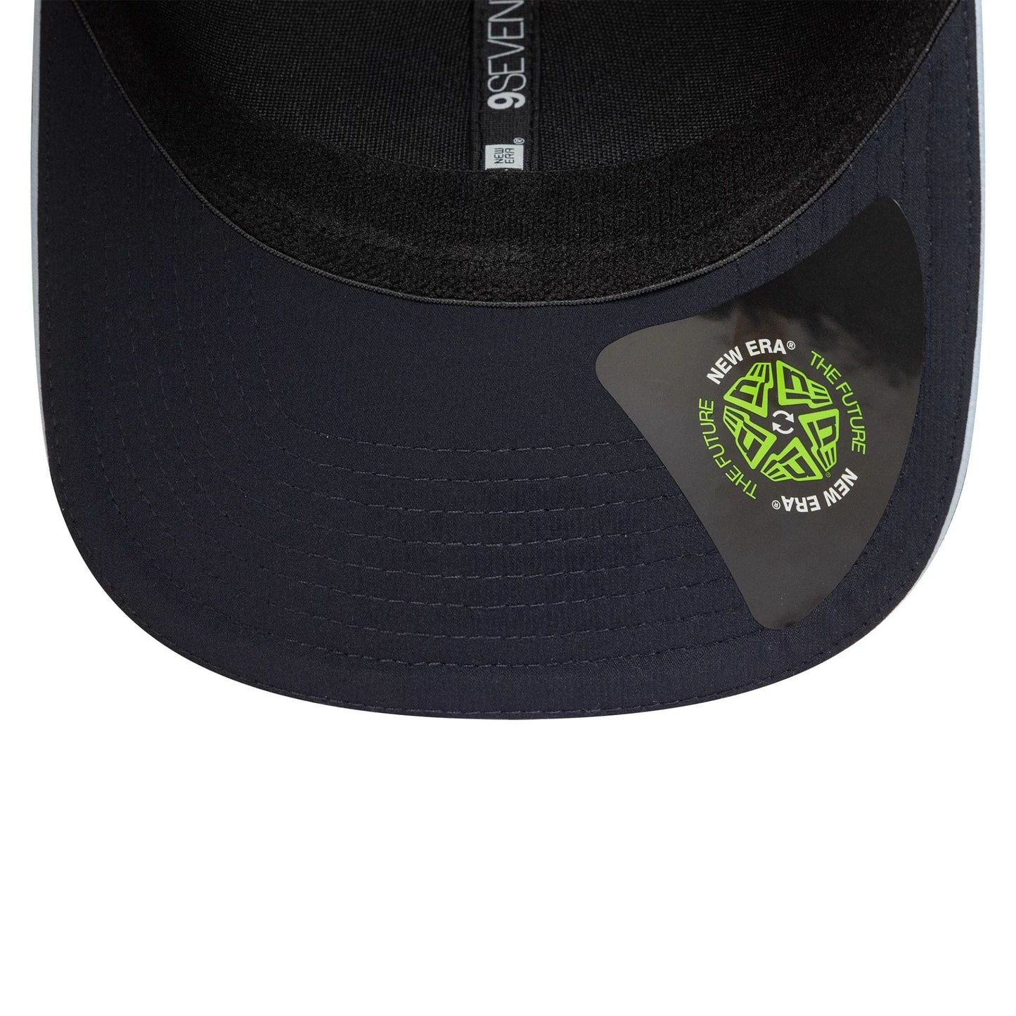 Tottenham Hotspur FC Cockerel Navy New Era 9SEVENTY Stretch Snap Cap, inside view showing black sweatband with grey taping featuring 9SEVENTY branding and a green New Era The Future sticker on the navy undervisor.