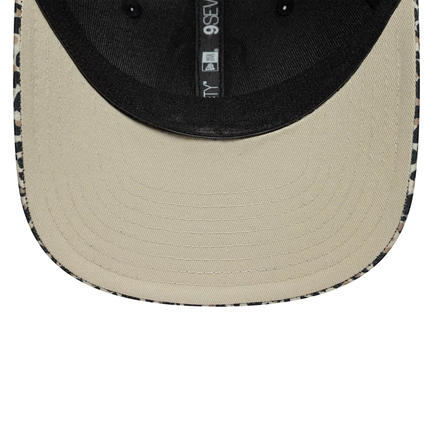 Visa Cash App Racing Bulls Leopard New Era 9SEVENTY Stretch Snap Cap, inside view showing the black taping and sweatband, with a beige undervisor and patterned leopard trim along the edge of the visor.