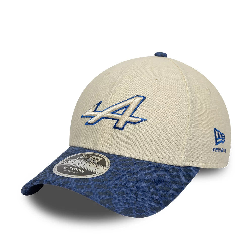 Alpine Racing Heritage Cream & Dark Blue New Era 9FORTY M-Crown Cap, front view showing a raised cream and blue embroidered A logo on the cream front panel, dark blue patterned visor, and 9FORTY size sticker.