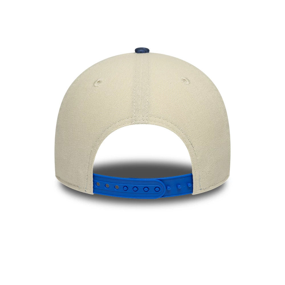 Alpine Racing Heritage Cream & Dark Blue New Era 9FORTY M-Crown Cap, rear view showing cream-coloured back panels with cream eyelets and a matching cream top button, featuring a blue adjustable snapback closure.