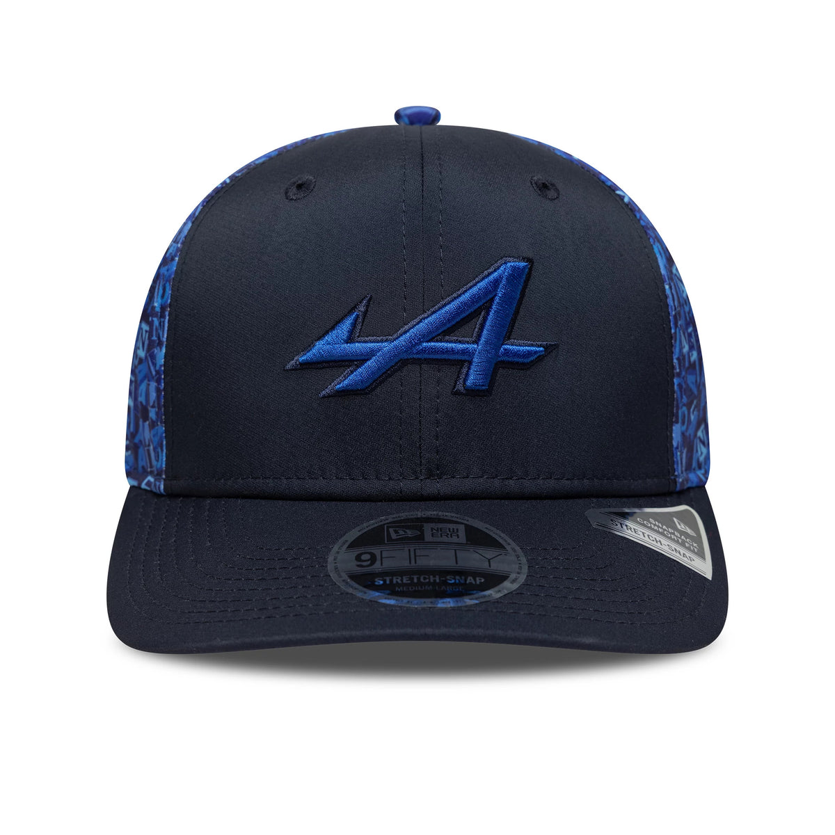 Alpine Racing All Over Print Navy New Era 9FIFTY Stretch Snap Cap, front view showing the large blue embroidered A logo on the structured navy front panels, with a black visor and a 9FIFTY size sticker on the undervisor.