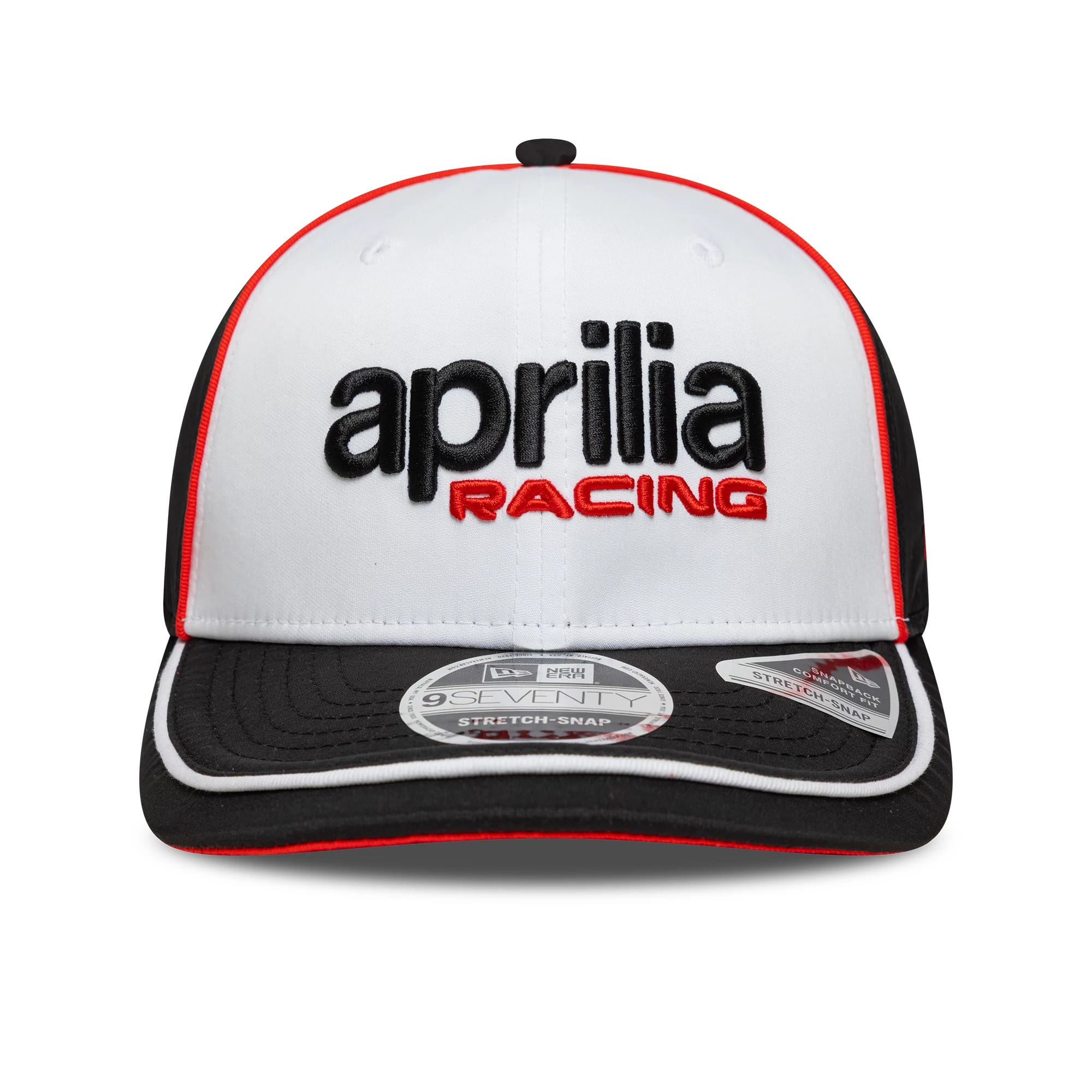 Aprilia Logo White New Era 9SEVENTY Stretch Snap Cap, front view showing black and red embroidered Aprilia Racing text on the white crown, with a black curved visor featuring a 9SEVENTY size sticker and red trim.