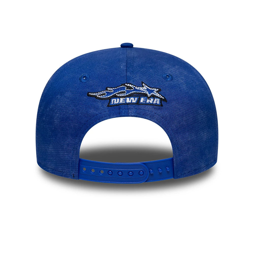Red Bull Racing Washed Denim Blue New Era 9SEVENTY Stretch Snap Cap, rear view showing a large black and white embroidered Red Bull Racing logo between two rear eyelets, above the blue snap closure on the washed denim crown.