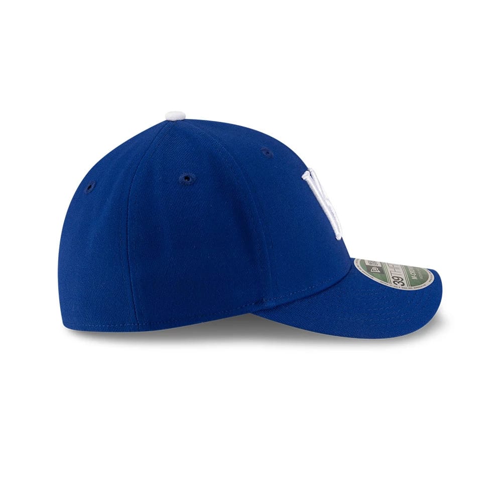 Royals MLB Player Replica Blue New Era 39THIRTY M-Crown Stretch-Fit Cap, side view showing the curved blue visor with a 39THIRTY size sticker, blue panels, eyelets and a white embroidered logo on the front panel.
