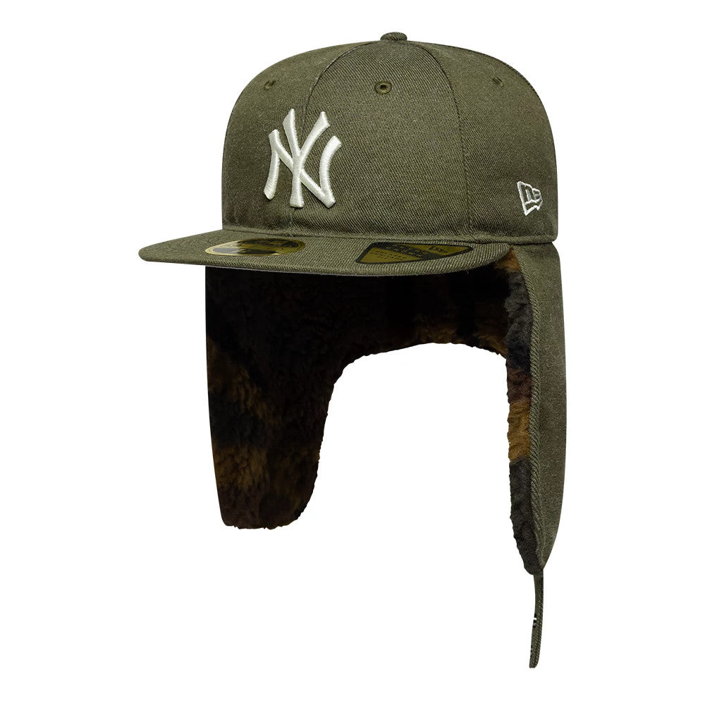 New York Yankees MLB Camo Open Green Retro Crown Dogear New Era 59FIFTY Fitted Cap, three-quarter view showing the raised white embroidered NY logo on the front, green visor with a gold 59FIFTY size sticker, and furry-lined earflaps hanging down.