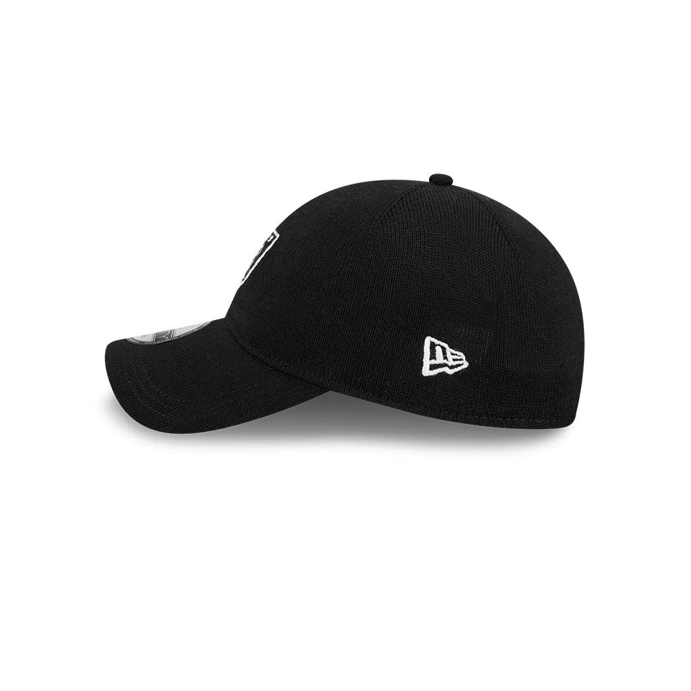 Las Vegas Raiders NFL Merino Wool Black New Era 9TWENTY Adjustable Cap, side view with the curved visor and white New Era flag logo embroidered on the left side of the black knitted crown.