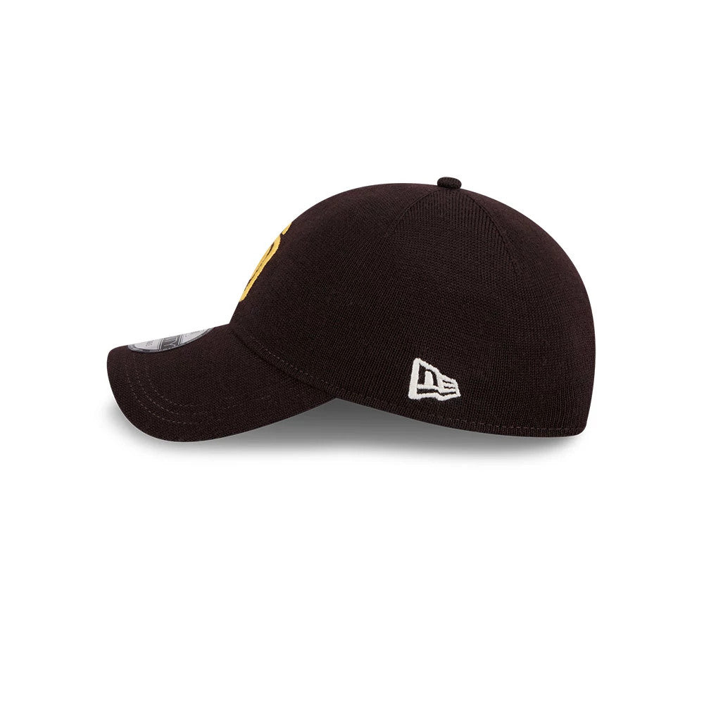 San Diego Padres MLB Merino Wool Dark Brown New Era 9TWENTY Adjustable Cap, side view showing the white embroidered New Era flag logo on the left side, with a curved visor and a size sticker on top.