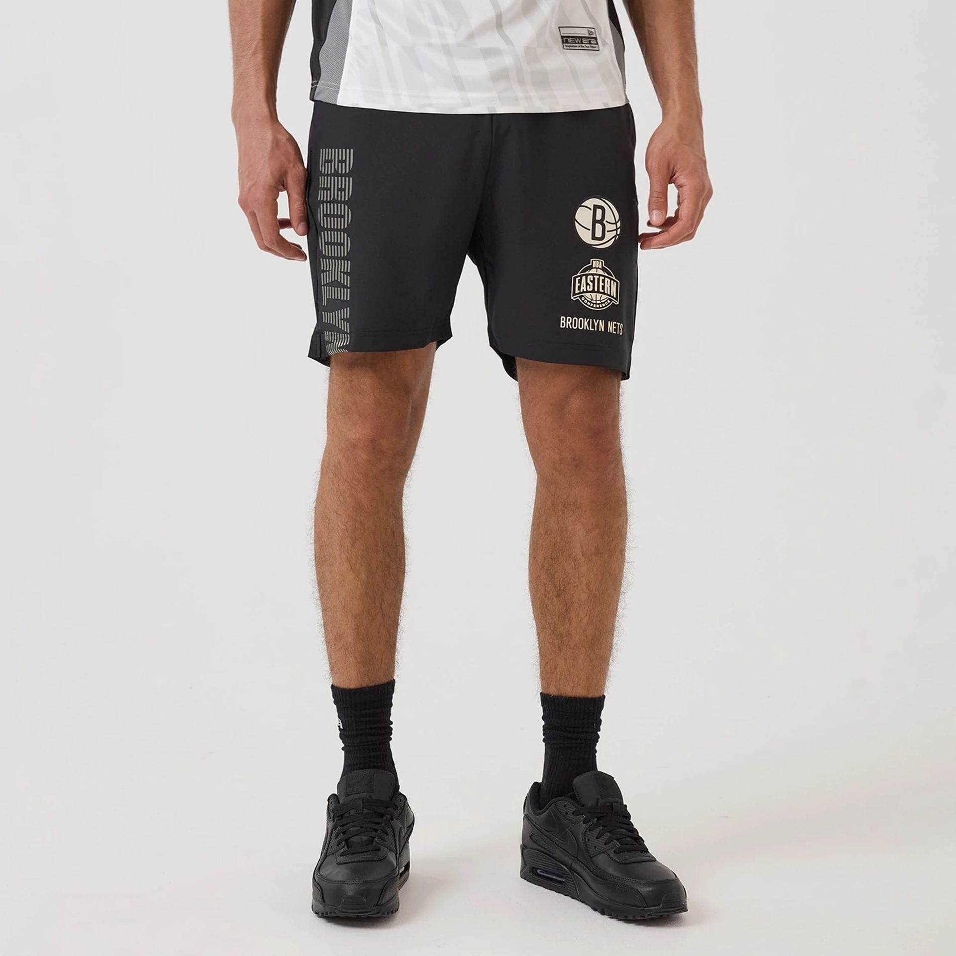 The model is wearing this NBA Match Brooklyn Nets Oversized Shorts in black. 1